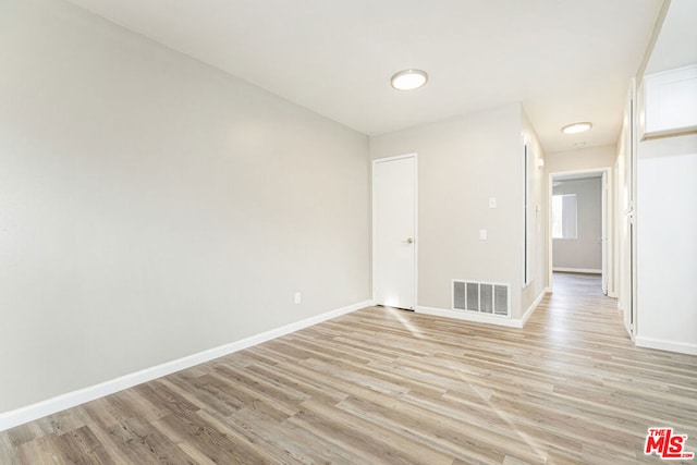 spare room with light hardwood / wood-style flooring