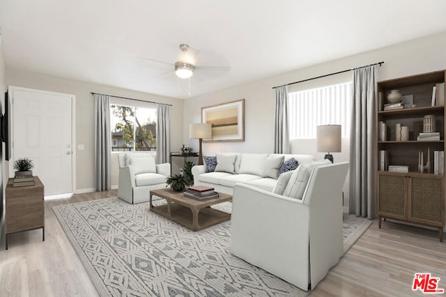 living room featuring ceiling fan and light wood-type flooring