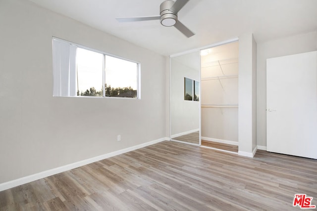 unfurnished bedroom featuring light hardwood / wood-style floors, a closet, and ceiling fan