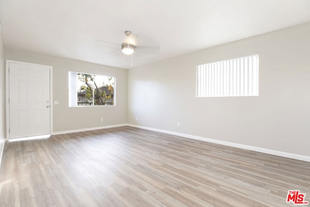 unfurnished room featuring light hardwood / wood-style floors and ceiling fan