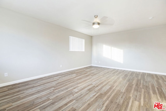 unfurnished room featuring light wood-type flooring and ceiling fan