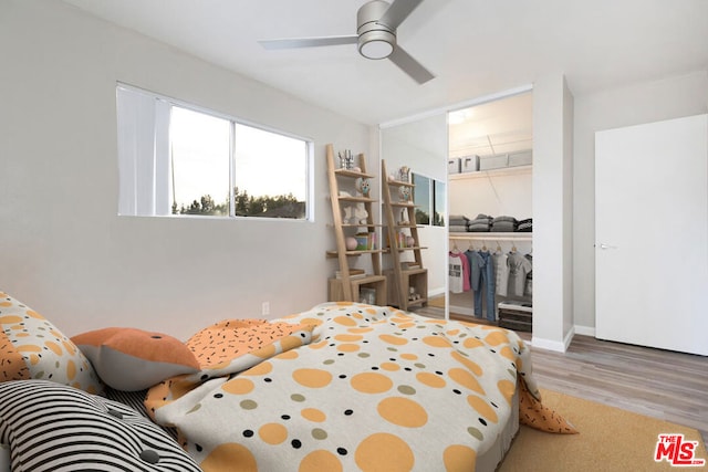 bedroom featuring hardwood / wood-style flooring, a closet, and ceiling fan