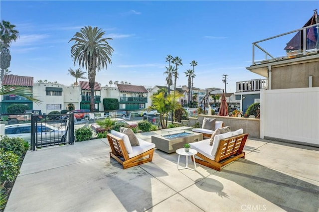 view of patio / terrace with an outdoor living space with a fire pit