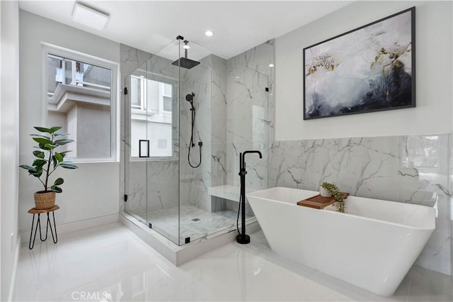 bathroom featuring separate shower and tub