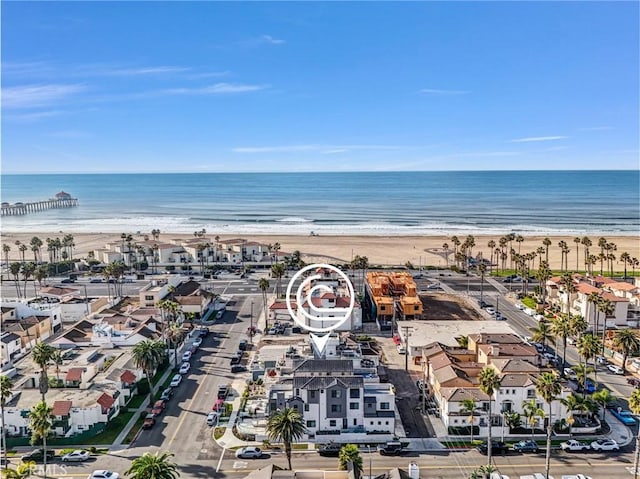 birds eye view of property featuring a water view and a beach view