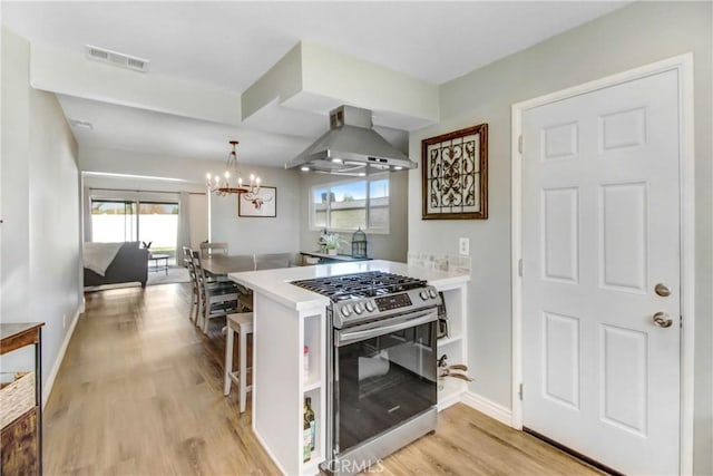 22616 Cardinal St, Grand Terrace, CA 92313 - kitchen featuring stainless steel gas range, extractor fan, plenty of natural light, and light wood-style floors