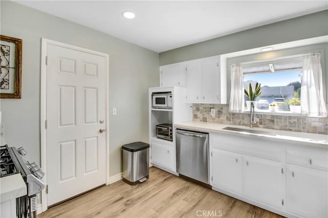 22616 Cardinal St, Grand Terrace, CA 92313 - kitchen with appliances with stainless steel finishes, a sink, backsplash, white cabinetry, and recessed lighting