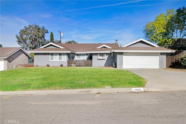 ranch-style home with a garage and a front lawn