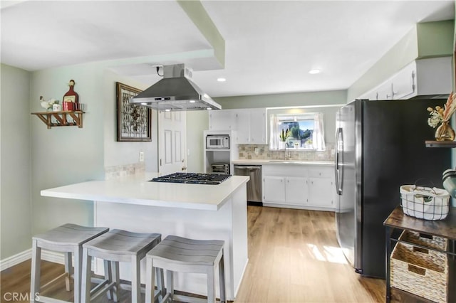 22616 Cardinal St, Grand Terrace, CA 92313 - kitchen featuring extractor fan, stainless steel appliances, a peninsula, light wood-style flooring, and recessed lighting