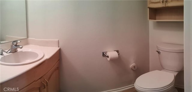 bathroom with toilet and vanity