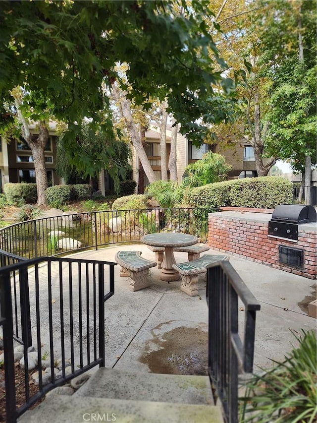 view of patio / terrace featuring exterior kitchen and a grill