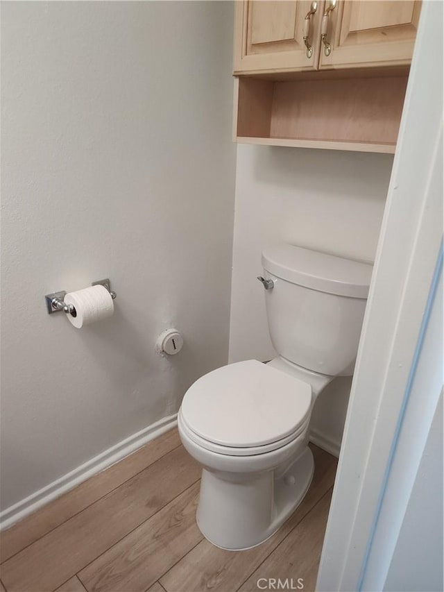 bathroom featuring hardwood / wood-style floors and toilet