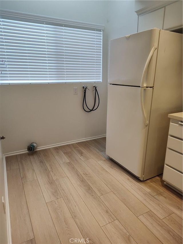 kitchen featuring white refrigerator and light hardwood / wood-style flooring