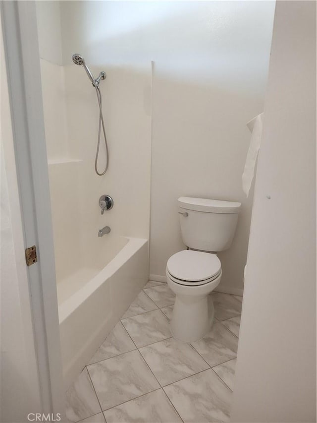 bathroom featuring tub / shower combination and toilet