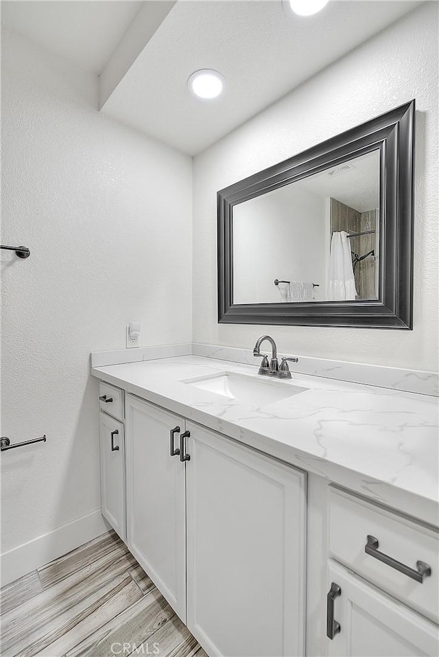 bathroom featuring hardwood / wood-style floors and vanity