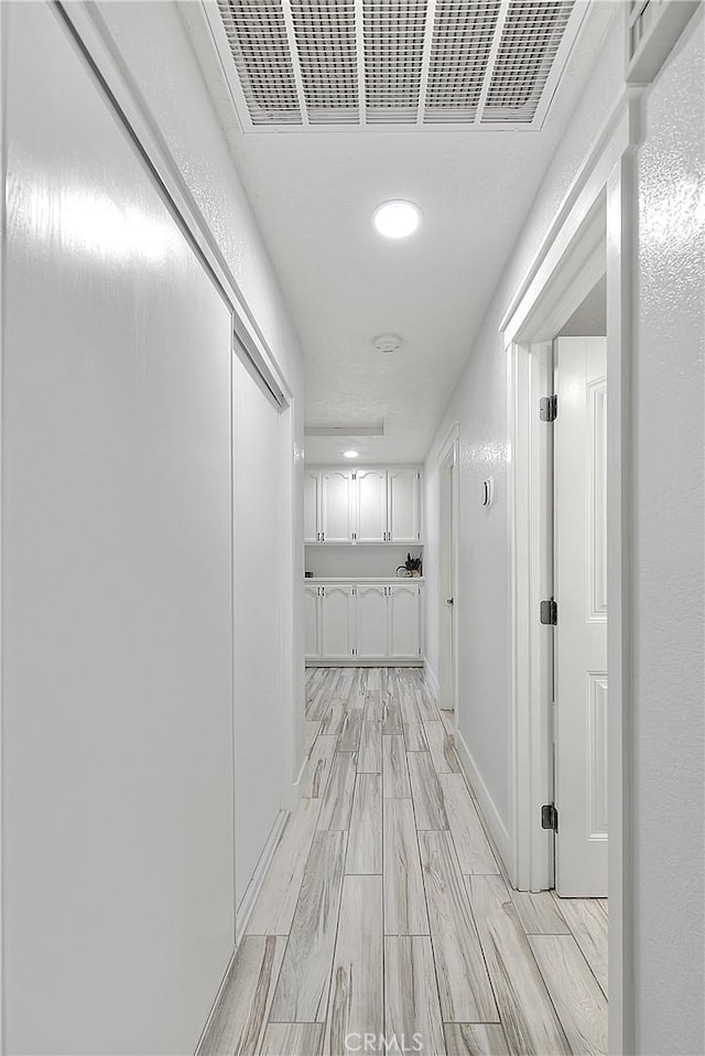 corridor featuring light hardwood / wood-style floors