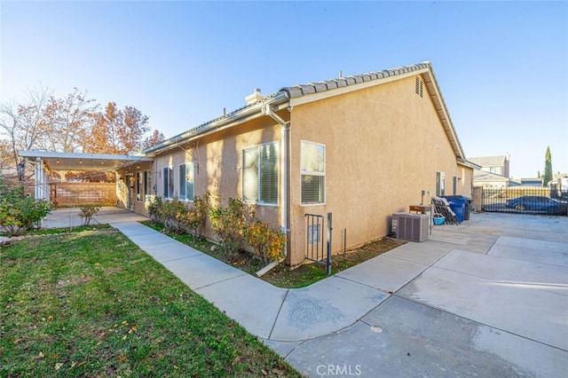 view of property exterior with a patio area and cooling unit