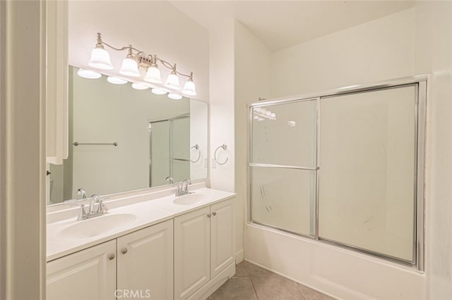 bathroom featuring enclosed tub / shower combo, tile patterned floors, and vanity