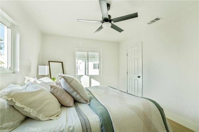 bedroom with ceiling fan and hardwood / wood-style floors