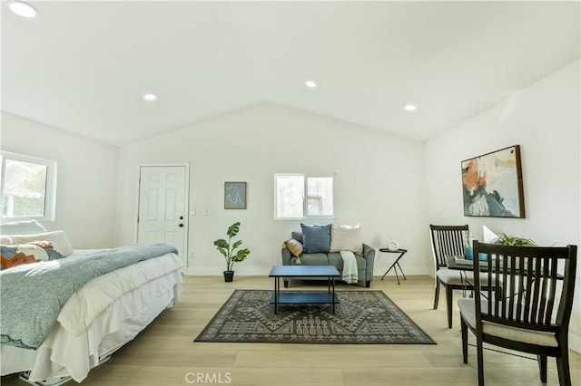 bedroom featuring lofted ceiling and light hardwood / wood-style flooring