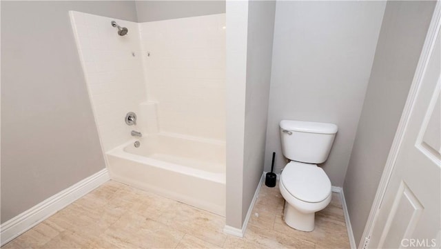 bathroom with washtub / shower combination and toilet