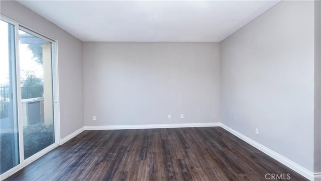 empty room with dark hardwood / wood-style floors