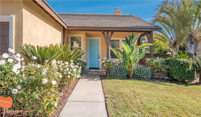 entrance to property with a yard