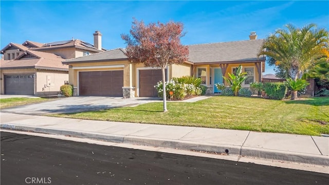 view of front of home featuring a front yard and a garage