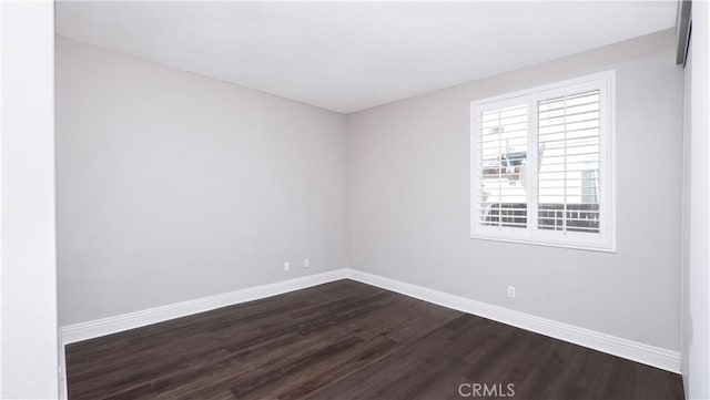 unfurnished room featuring dark wood-type flooring