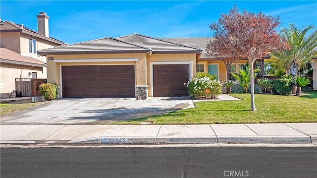 view of front of house featuring a garage and a front lawn