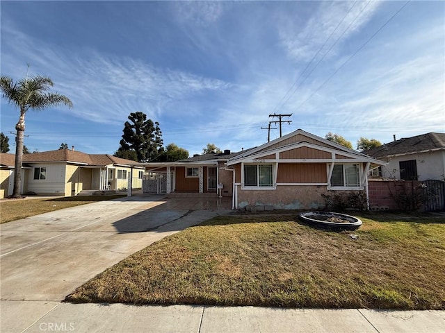 view of front of property with a front yard and a carport