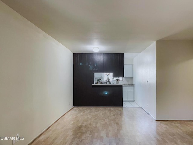 kitchen featuring white cabinets and light hardwood / wood-style flooring