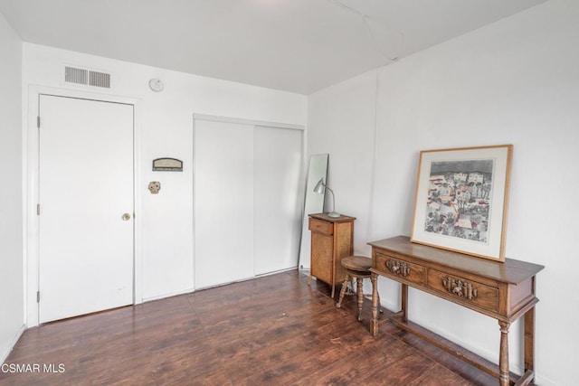 interior space featuring dark hardwood / wood-style flooring and a closet