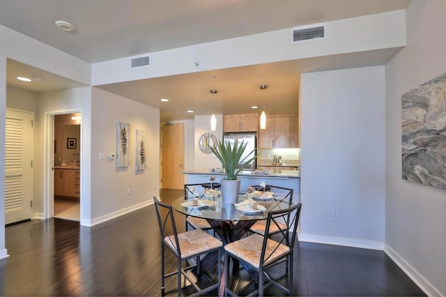 dining area featuring dark hardwood / wood-style flooring