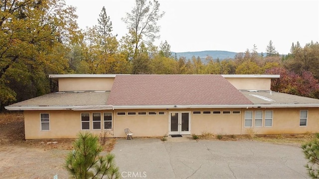 rear view of property featuring a mountain view and french doors