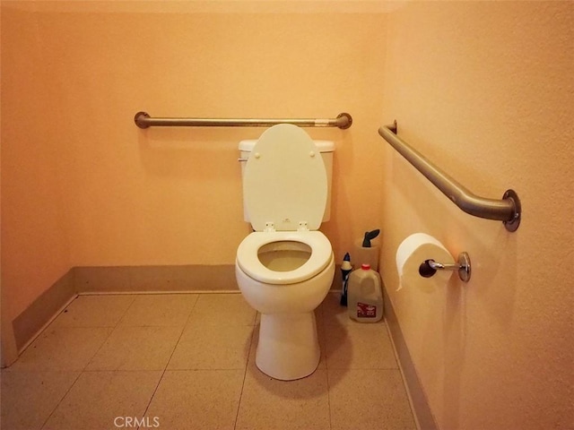 bathroom featuring toilet and tile patterned flooring