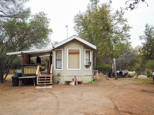 back of property featuring a wooden deck and cooling unit