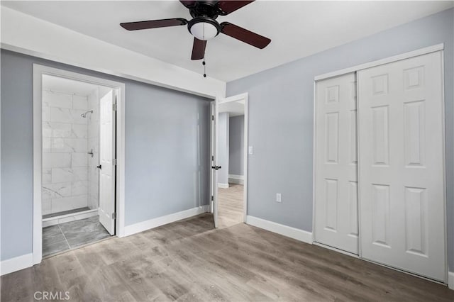 unfurnished bedroom with ceiling fan, a closet, connected bathroom, and hardwood / wood-style floors