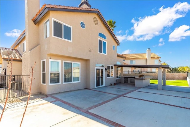 rear view of property featuring a patio area