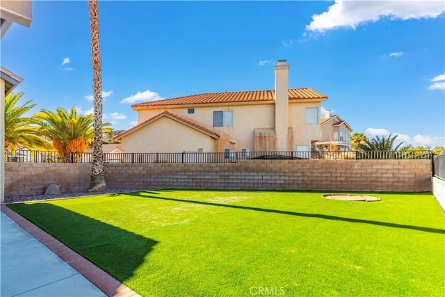 rear view of house featuring a lawn