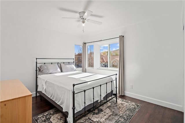 bedroom with ceiling fan and dark hardwood / wood-style floors