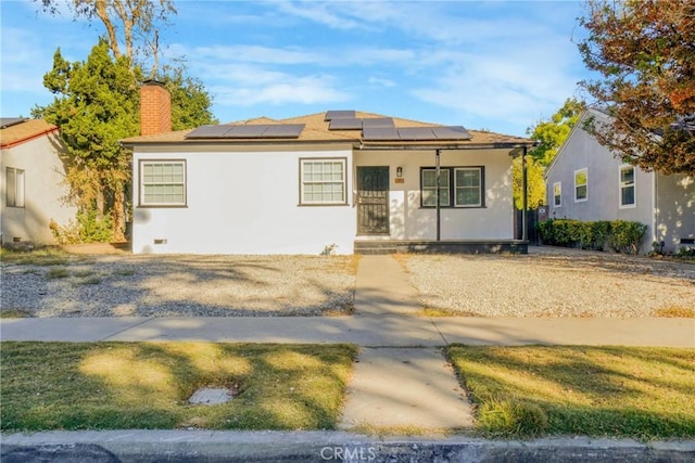 view of front of house featuring covered porch and solar panels