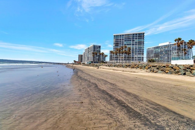 view of water feature featuring a city view and a beach view