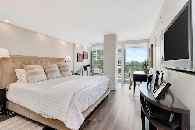 bedroom with recessed lighting and wood finished floors