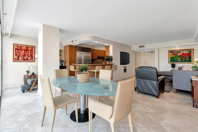 dining room featuring light tile patterned floors and visible vents