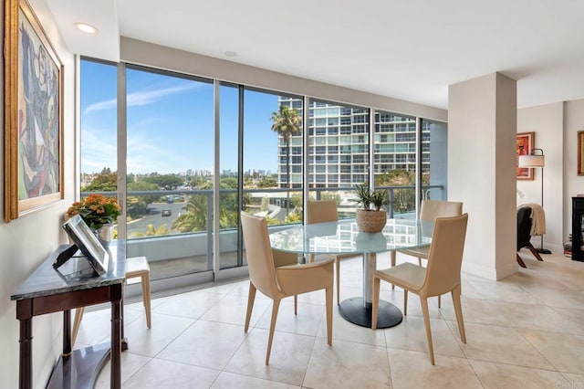 dining area featuring light tile patterned floors and baseboards