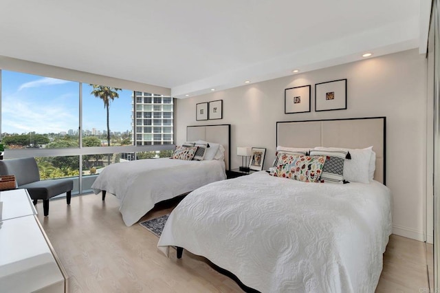 bedroom with recessed lighting and light wood-type flooring