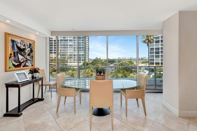 tiled dining room with recessed lighting, baseboards, and a view of city