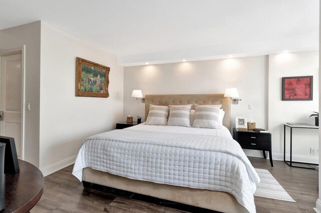 bedroom featuring baseboards, wood finished floors, and recessed lighting