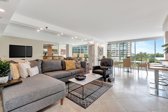 living room with floor to ceiling windows, recessed lighting, and light tile patterned floors